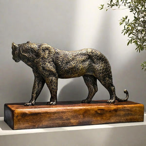 Back angle view of antique bronze money leopard statue with plant decor in indoor display