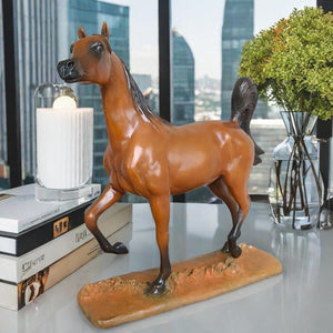 Arabian stallion bronze sculpture warm earth finish displayed in modern living room with candles