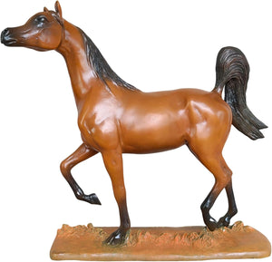 Arabian stallion bronze sculpture warm earth finish displayed on shelf beside framed black and white art