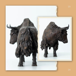 Giant black bronze bison art in a luxury gallery setting.