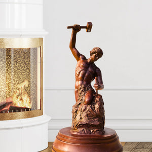 Bobbie Carlyle Self-Made Man bronze sculpture displayed beside fireplace in warm interior