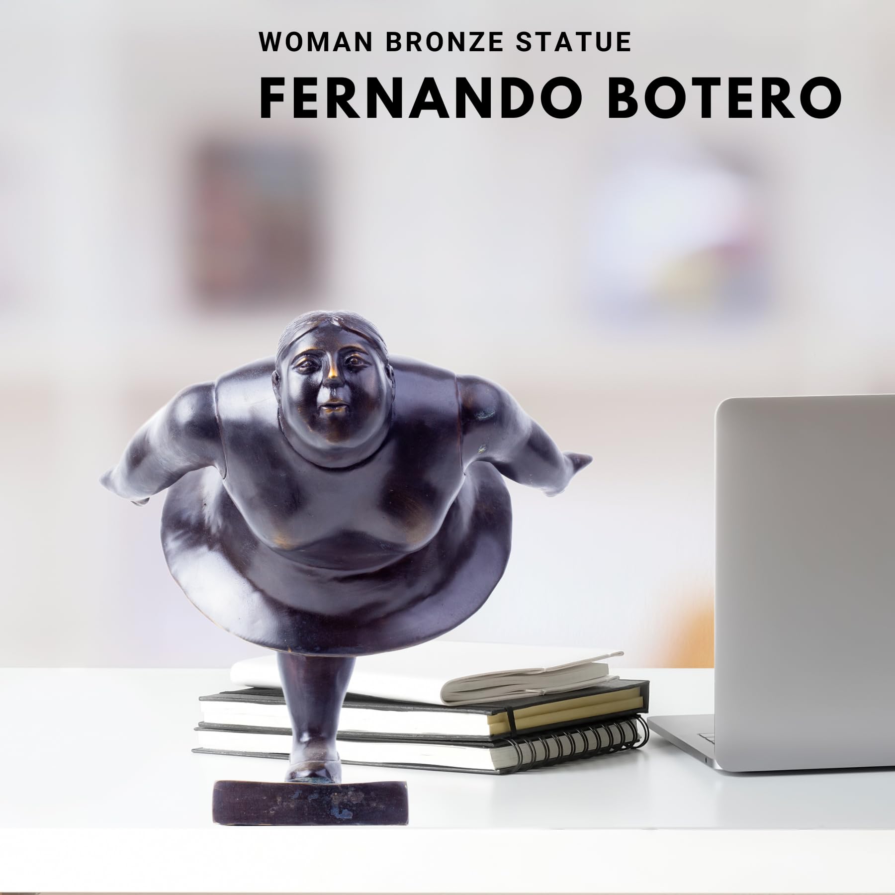 Botero bronze ballerina figurine next to book for size scale reference