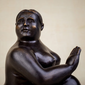 Rear view of curvy female yoga bronze figurine showing full figure and base detail