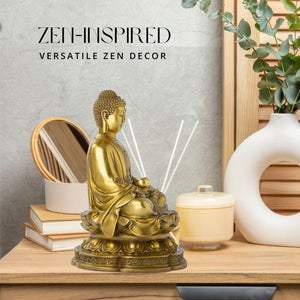 Brass meditating Buddha statue styled as zen decor on desk beside candles and aromatherapy accessories