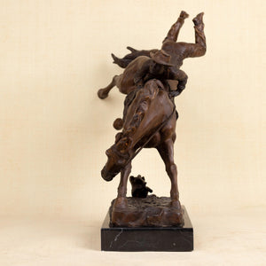 Side view of large Bronco Buster bronze sculpture showing intricate detail of cowboy and bucking horse