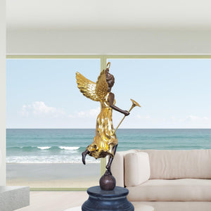 Bronze angel statue pair displayed in coastal living room ocean view interior