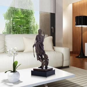 Bronze Augustus Caesar Roman emperor statue displayed on coffee table in living room with sofa background