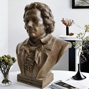 Bronze Beethoven bust statue displayed with floral arrangement in indoor setting