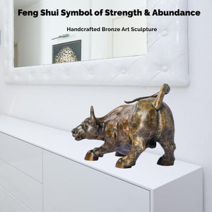 Intricate musculature details on the patterned bronze charging bull statue