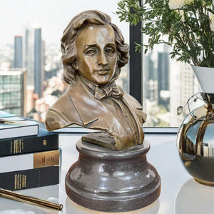 Bronze Frédéric Chopin bust statue on marble base displayed by highrise city window