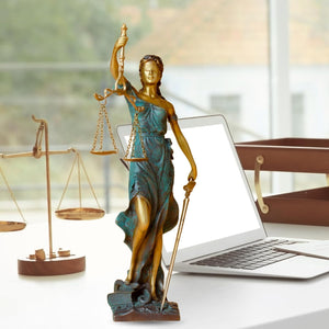 11-inch teal bronze Lady Justice Themis statue with scales displayed on office desk alongside laptop