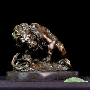 Dark bronze lion and serpent sculpture after Barye on marble base displayed against black background