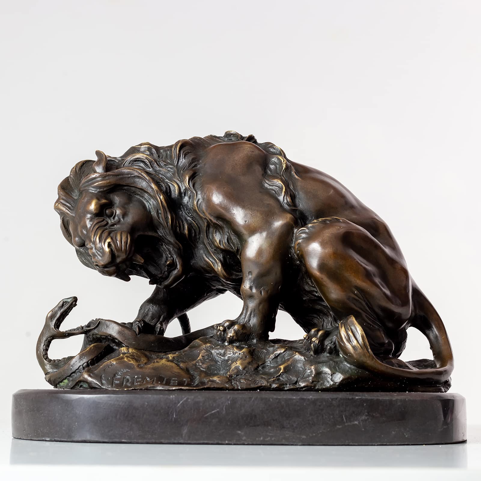 Dark bronze patina lion and serpent sculpture after Barye on marble base, side view beige background