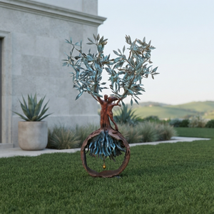 The 1.2-meter-tall handcrafted bronze olive tree and embracing couple sculpture standing on a manicured green lawn outside a modern luxury villa with clean stone facades and distant rolling hills.