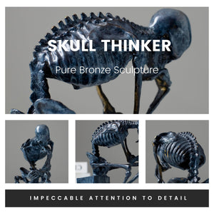 Close-up of bronze skeleton Thinker statue in blue-grey patina showing detailed skull and ribcage sculpting