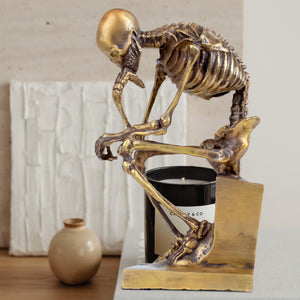 Bronze skeleton Thinker statue in gold finish on desk with size dimension reference