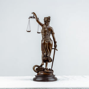 Bronze Themis Lady Justice statue side full body view on white background showing flowing robe detail
