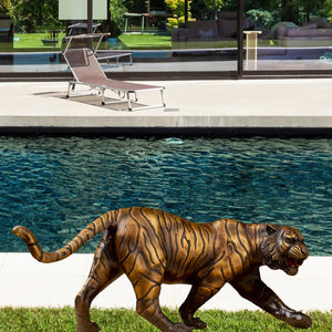 Bronze tiger statue displayed outdoor garden pathway natural setting
