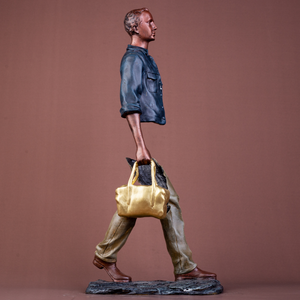 Close-up of the detailed facial features and polished bronze finish of the traveler statue.