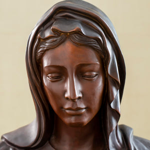 Close-up front detail of bronze Virgin Mary bust statue showing serene facial expression and veil