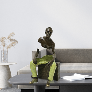 Bruno Catalano Les Voyageurs seated bronze fragmented sculpture displayed on living room sofa