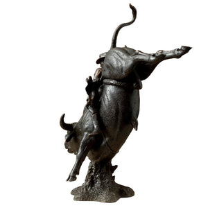 Close-up detail of the cowboy rider on the heavyweight bronze rodeo sculpture