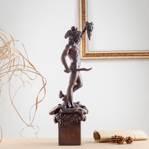 Left view of dark brown Cellini Perseus Medusa bronze statue on decorative pedestal
