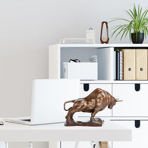 Bronze bull figurine styled on an executive office desk.