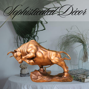 Golden yellow charging bull displayed on executive desk decor.