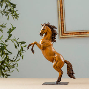Gold bronze rearing stallion desk edition sculpture angle view with greenery and frame