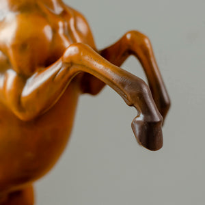 Close-up detail of gold bronze rearing stallion desk edition sculpture neck and raised leg