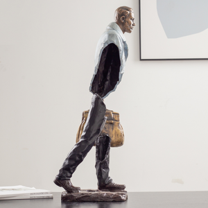 Side view of the fragmented man bronze statue in a modern grey white finish.
