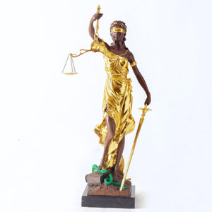 Front angle view of gilded bronze Lady Justice Themis pure bronze statue on warm brown background