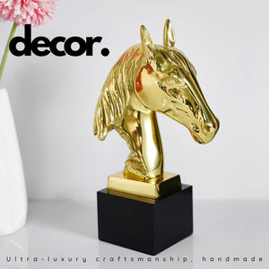 Gold brass horse head statue displayed as luxury decor with indoor floral arrangement lifestyle setting