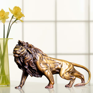 Gold bronze Lion King sculpture displayed alongside fresh flowers in bright indoor lifestyle setting