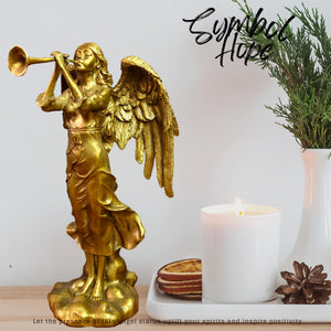 Golden brass angel trumpet statue elegant display beside tropical plants interior