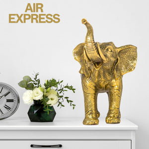 Golden brass elephant statue elegant craftsmanship feature image displayed beside candles and decor
