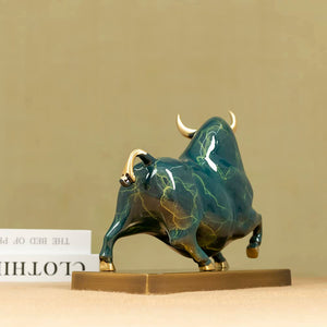 Artistic green enamel glaze texture on charging bull figurine.