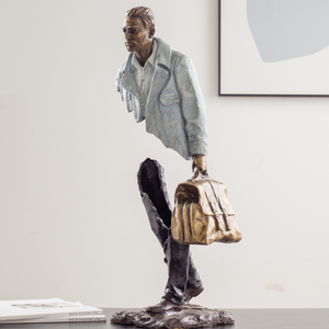 Close-up of the bearded face on the stone greyish white traveler bronze statue.
