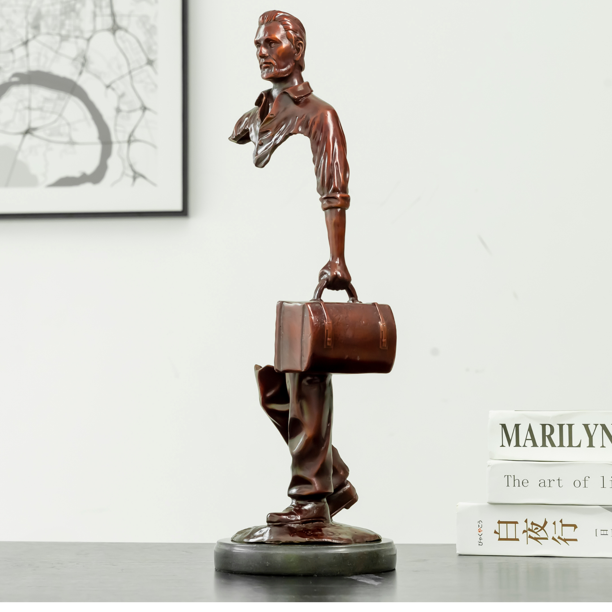 Side view of the 16.9 inch hollowed-out bronze traveler statue showing surrealist design.