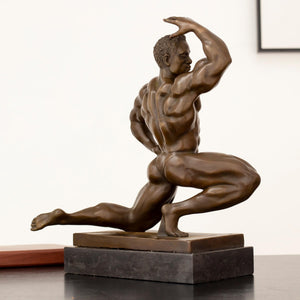 Front pose view of solid hot-cast bronze kneeling bodybuilder sculpture on rectangular marble base