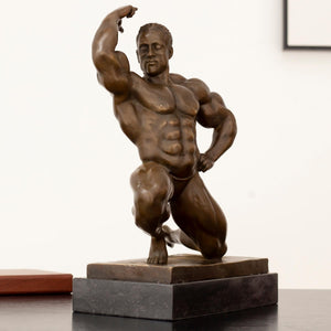 Right angle view of kneeling bodybuilder bronze sculpture highlighting aesthetic muscle posing detail