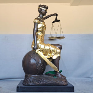 Large gold bronze Lady Justice Themis seated statue front display showing scales and flowing robe