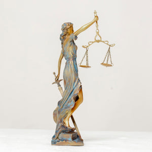 Multicolor Lady Justice Themis statue side full body view on white background