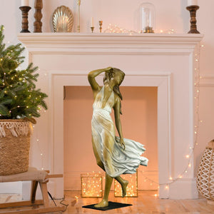 Neoclassical bronze wind dancer gold dress beside fireplace luxury interior