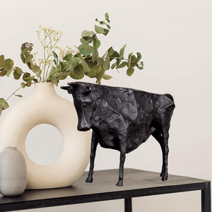 Minimalist black bull statue in a contemporary home interior.