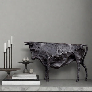 Handcrafted texture detail of black abstract bull decor.