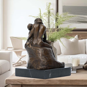Rodin The Kiss bronze statue displayed in living room beside sofa as romantic home decor