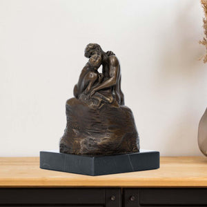 Rodin The Kiss bronze statue displayed in front of decorative mirror frame as elegant home decor