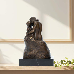 Rodin The Kiss bronze statue displayed on shelf beside framed wall art in modern interior